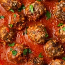 Porcupine meatballs simmering in marinara sauce.