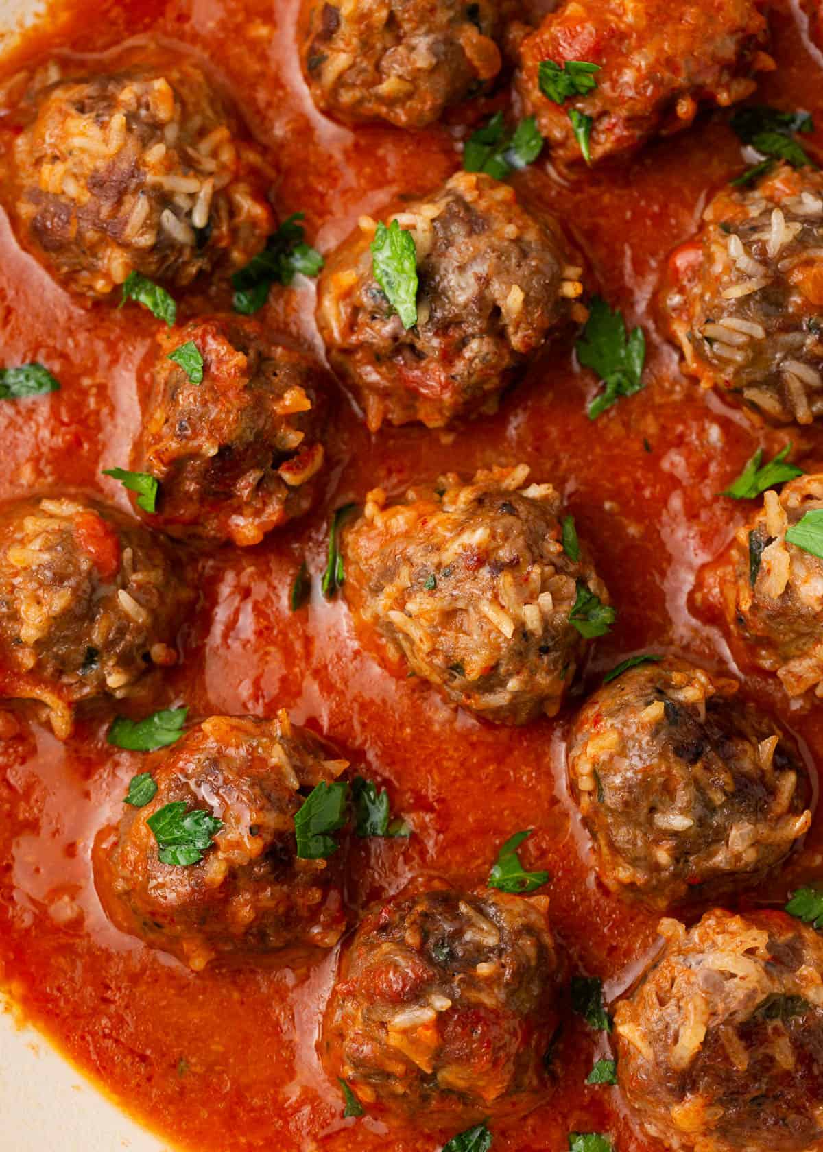 Porcupine meatballs simmering in marinara sauce.