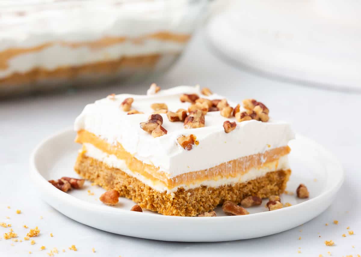 Pumpkin lasagna with pecans on a white plate.