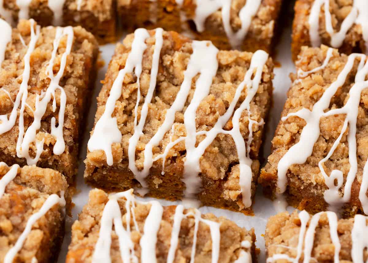 Sliced pumpkin coffee cake with a glaze on top.