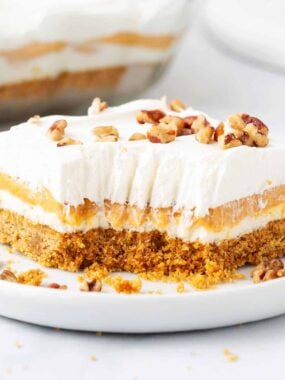 Pumpkin lasagna with bite taken on a white plate.