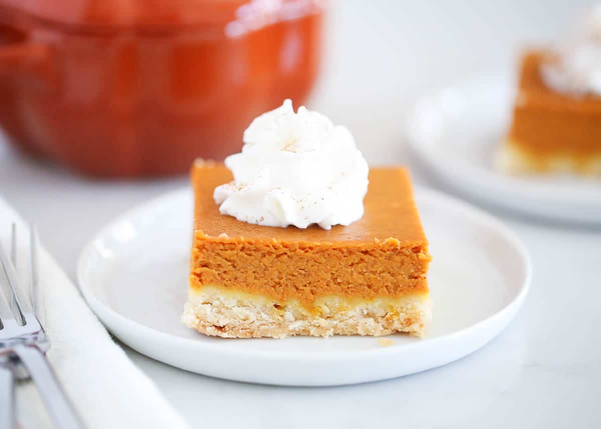 Pumpkin pie bar slice on a white plate.