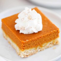 Pumpkin pie bar with whipped cream on top.