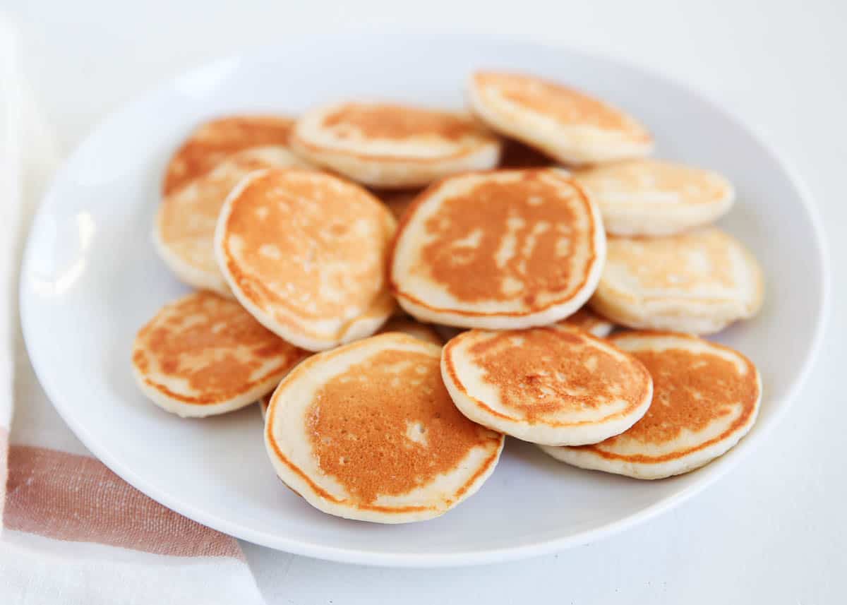 Mini Silver Dollar pancakes on a white plate.