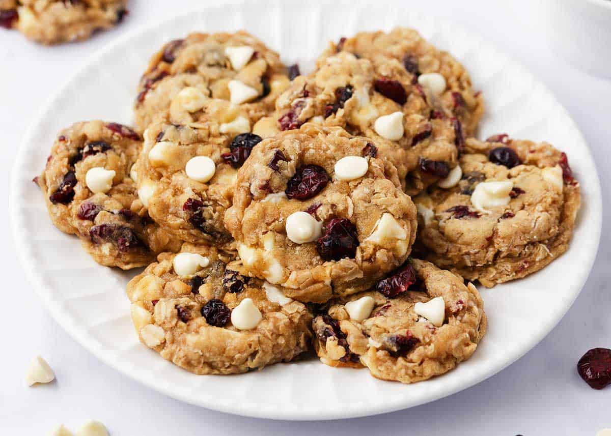 Stack of oatmeal cranberry cookies on a white plate.