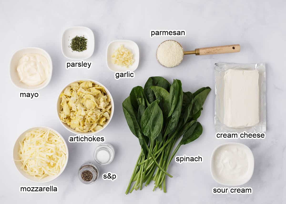 Oven baked spinach artichoke dip ingredients on counter.
