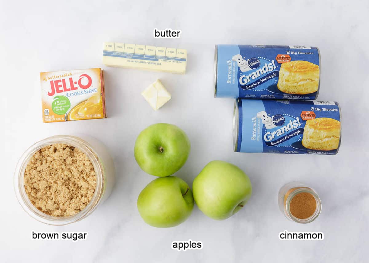 Apple monkey bread ingredients on marble counter.