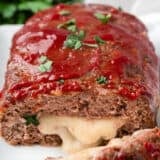 Sliced stuffed meatloaf on plate.