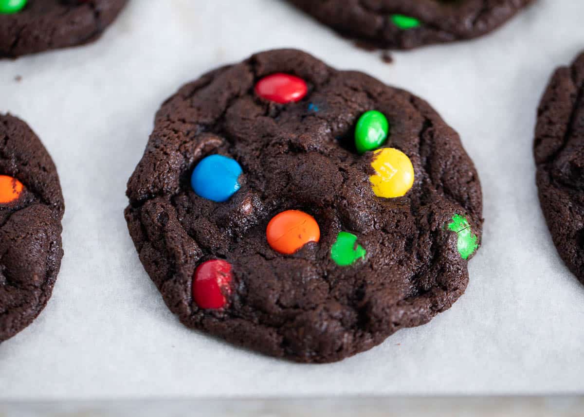 Chocolate m&m cookies on a baking sheet.