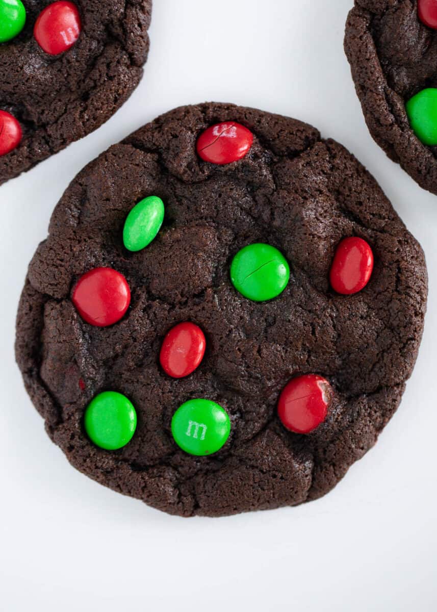 Christmas m&m chocolate cookie on a white plate.