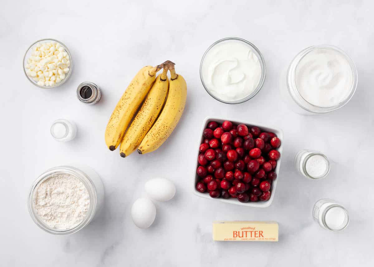 Cranberry banana bread ingredients on a marble counter.