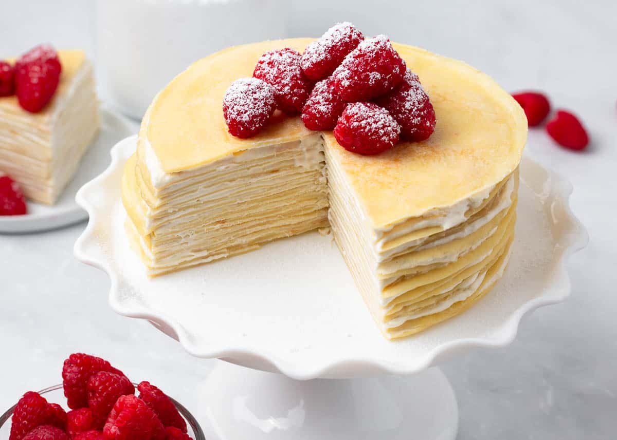 Crepe cake on white cake stand.