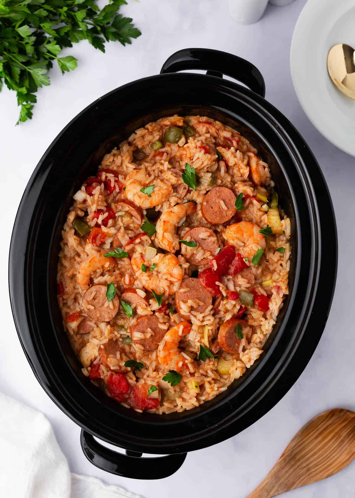 Jambalaya cooked in a crockpot on counter.