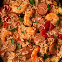 Jambalaya cooked in a black slow cooker.