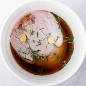 Turkey brining in a white bucket.