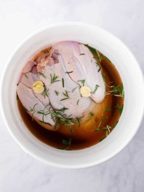 Turkey brining in a white bucket.