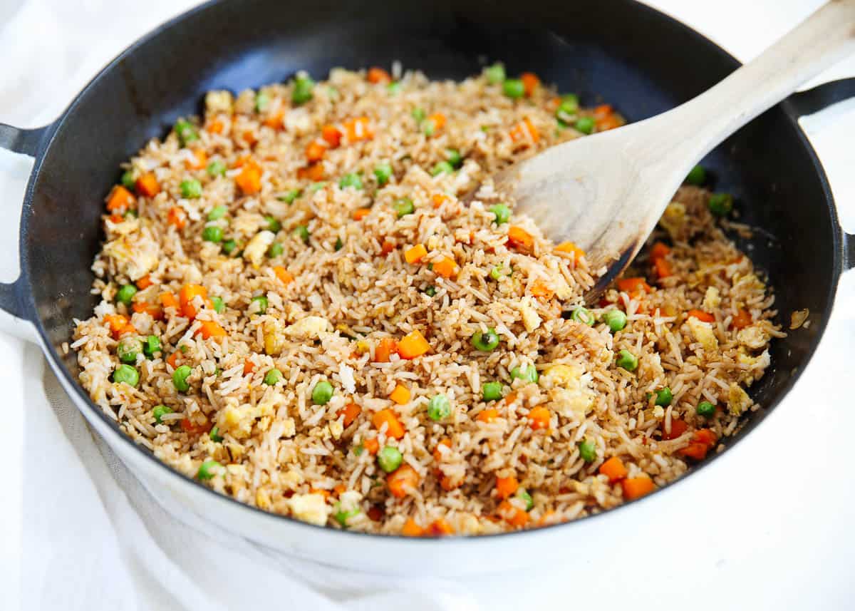 Cooking fried rice in a skillet.