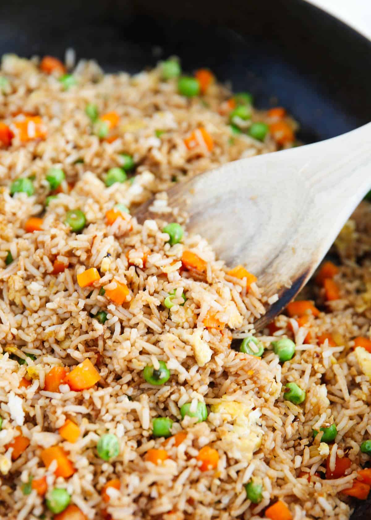 Spoonful of fried rice in a skillet.