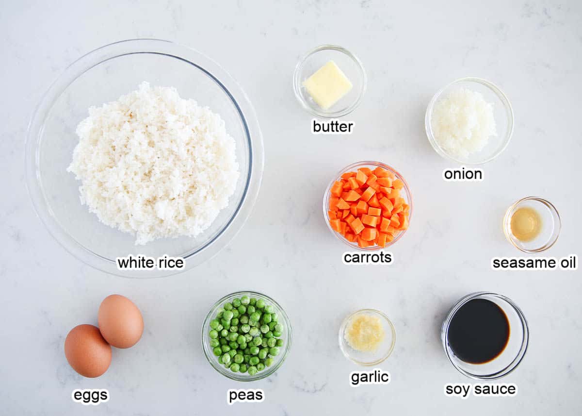 Fried rice ingredients on a marble countertop.