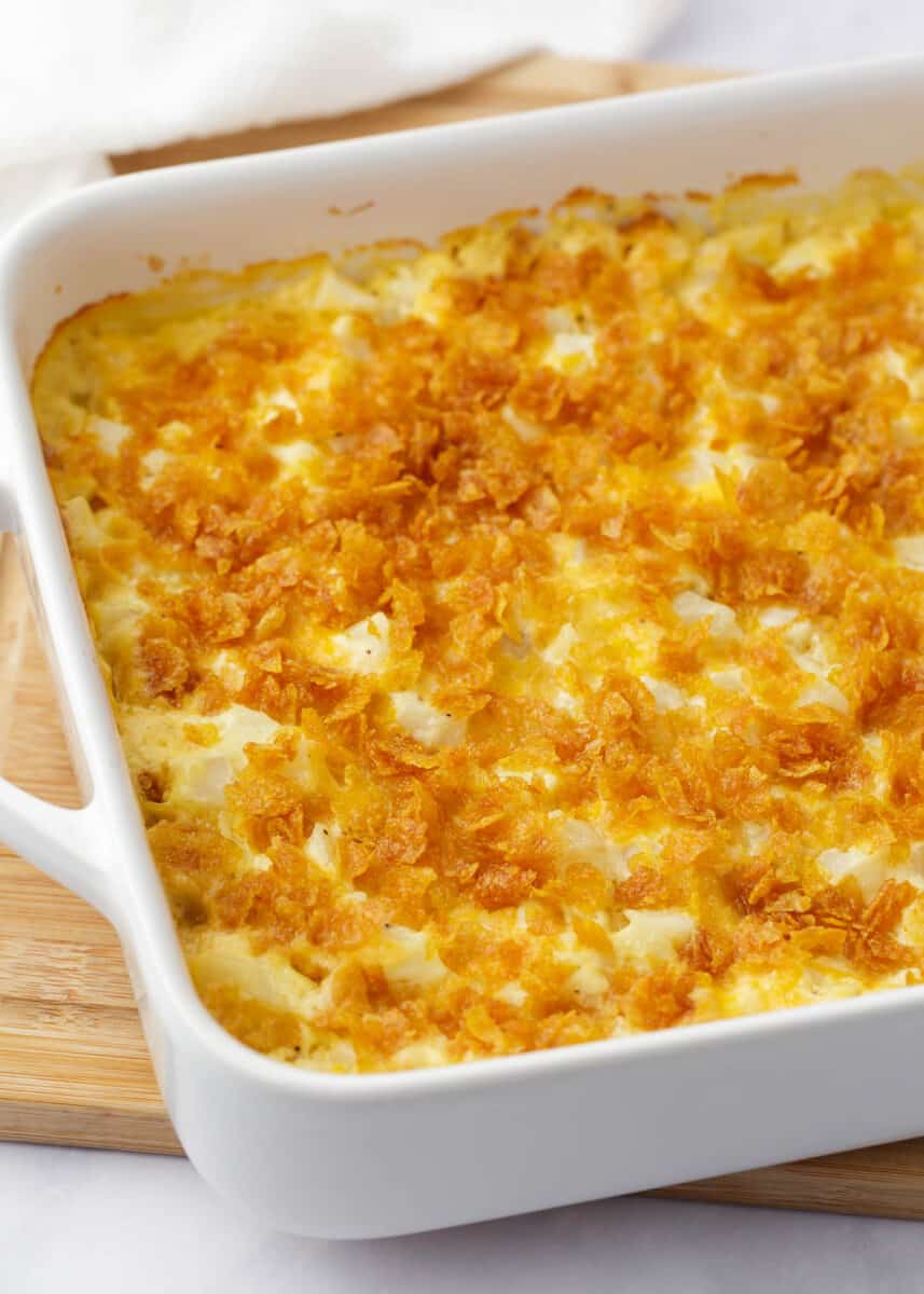 Funeral potatoes in a white baking dish.