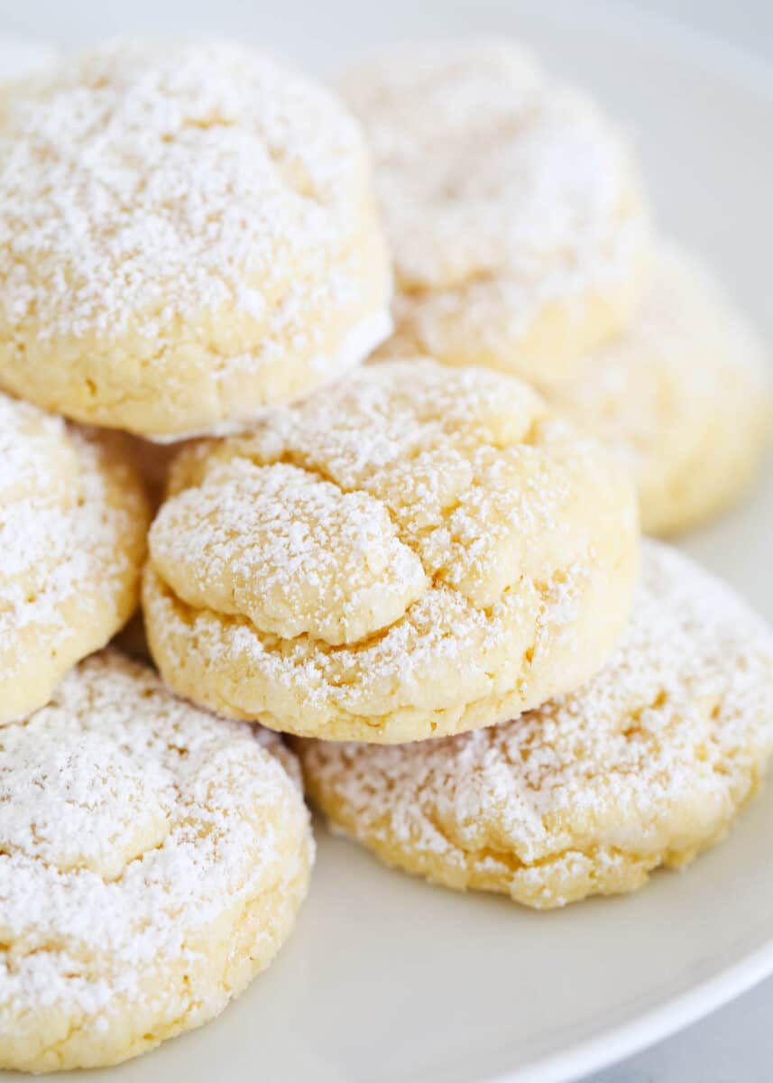 Gooey butter cookies with powdered sugar on plate.