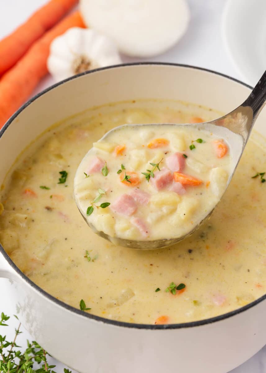 Pot full of ham and potato soup. 