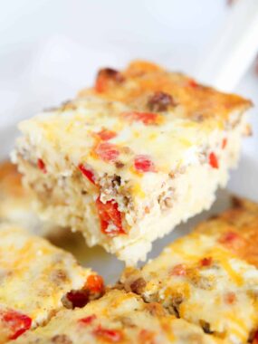 Slice of hashbrown breakfast casserole in a white baking dish.