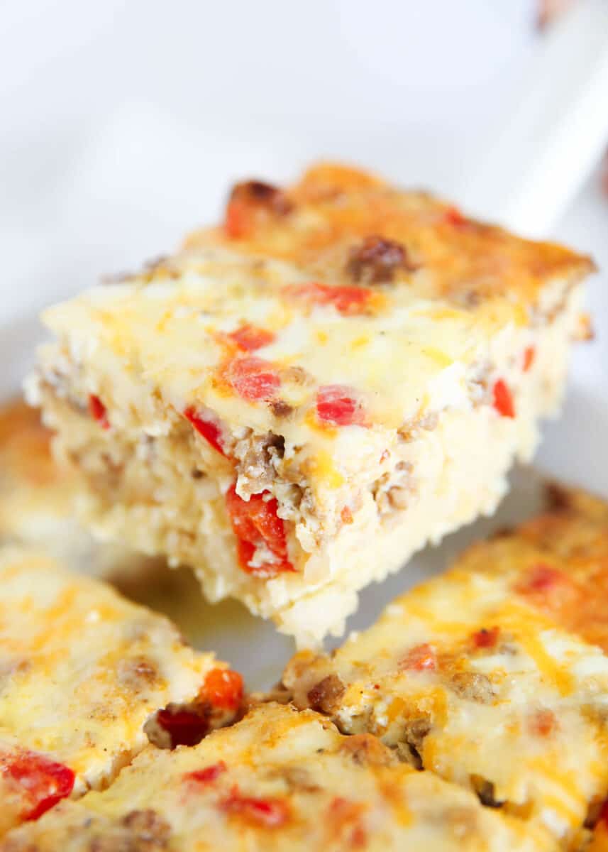 Slice of hashbrown breakfast casserole in a white baking dish.