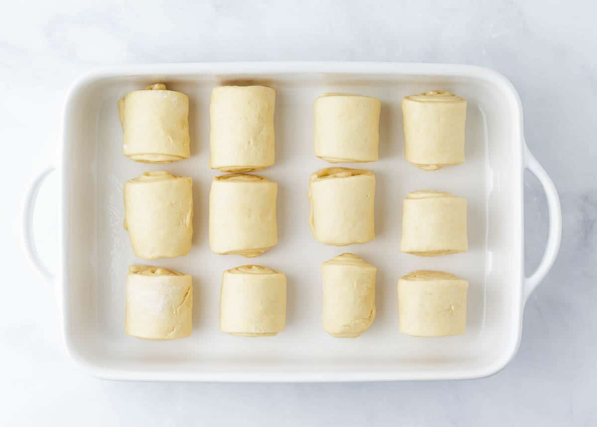 Parker house rolls rolled in a baking dish.