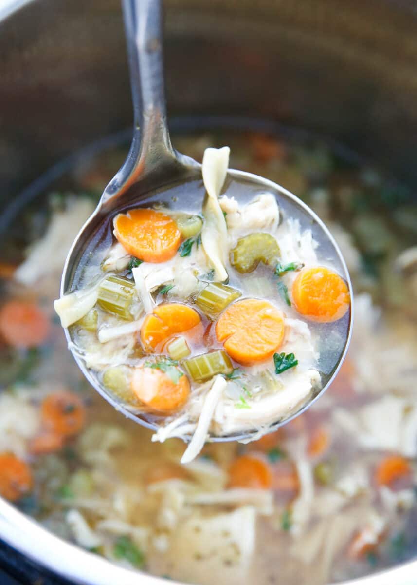 Ladle full of chicken noodle soup in the instant pot.