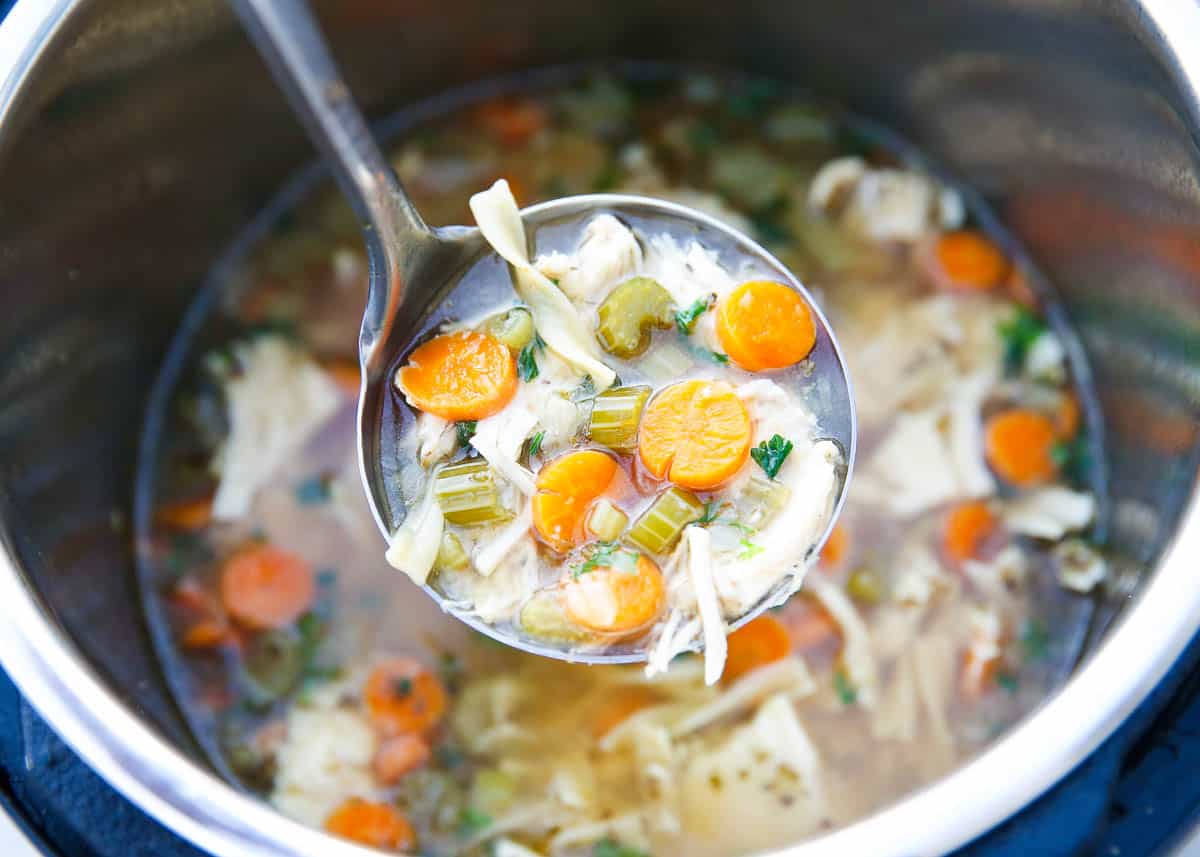 Ladle full of chicken noodle soup in the instant pot. 