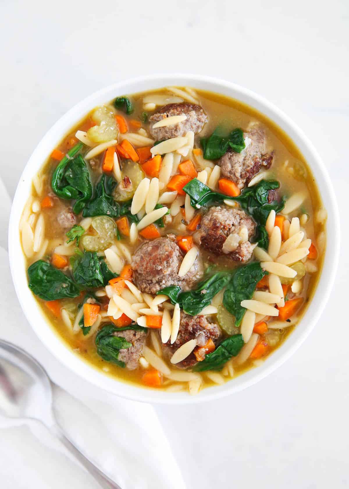 Italian Wedding soup in a white bowl.