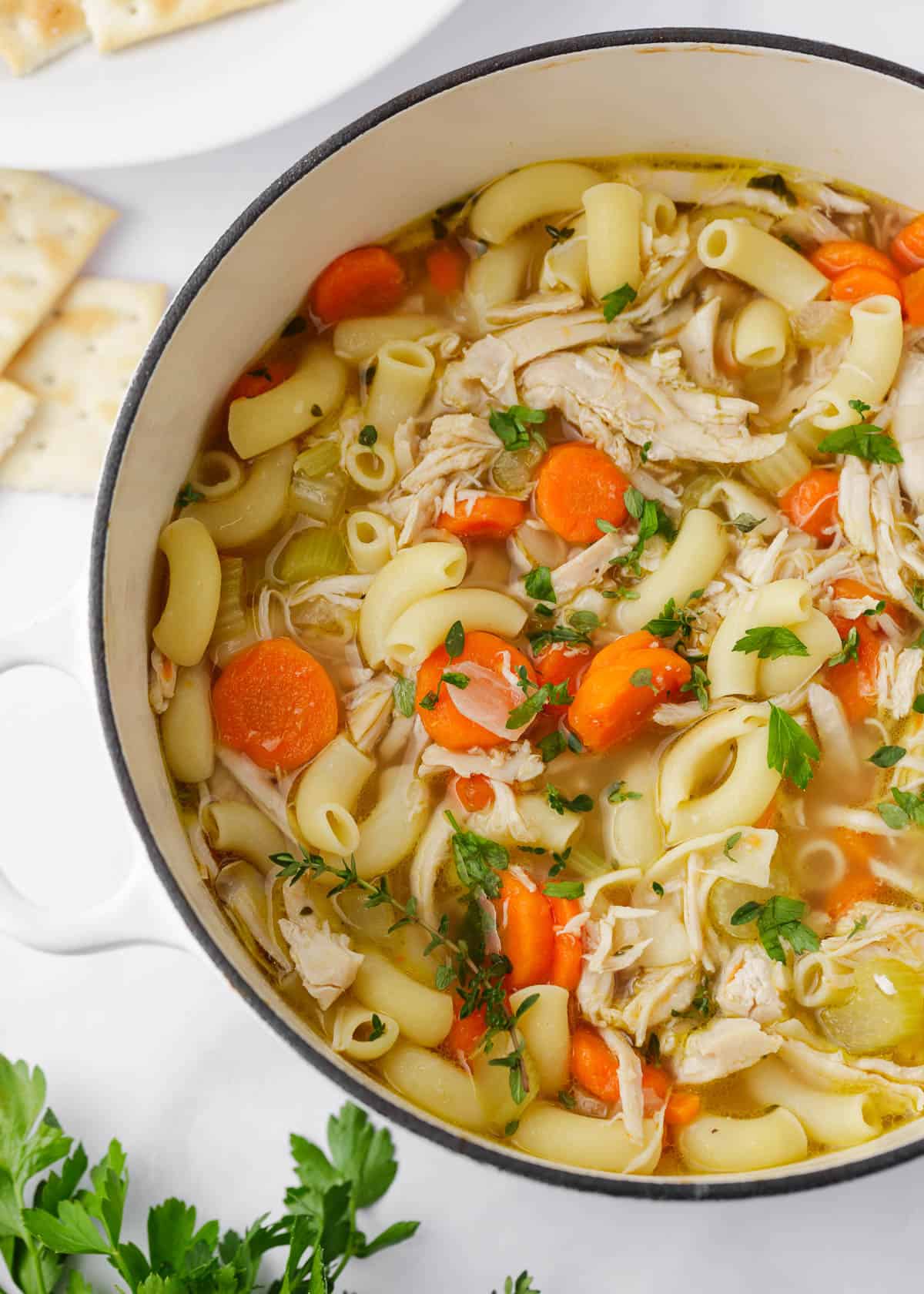 Turkey soup in a white pot.