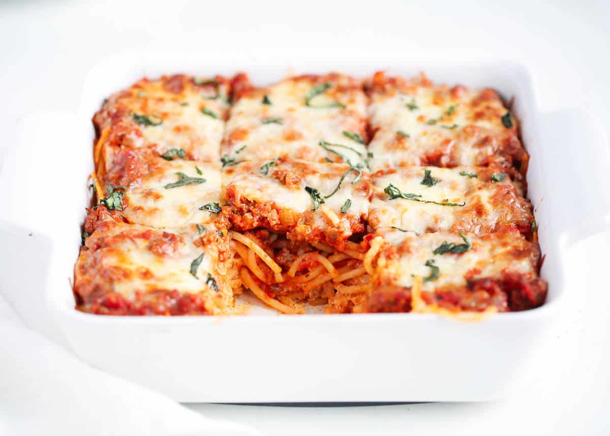 Million dollar spaghetti casserole in a baking dish on counter.