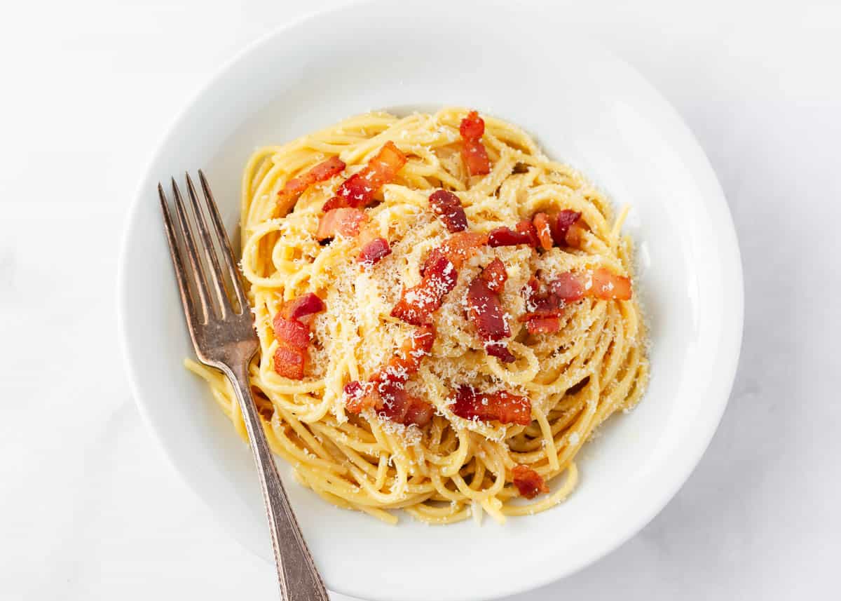 Pasta carbonara in a white bowl. 