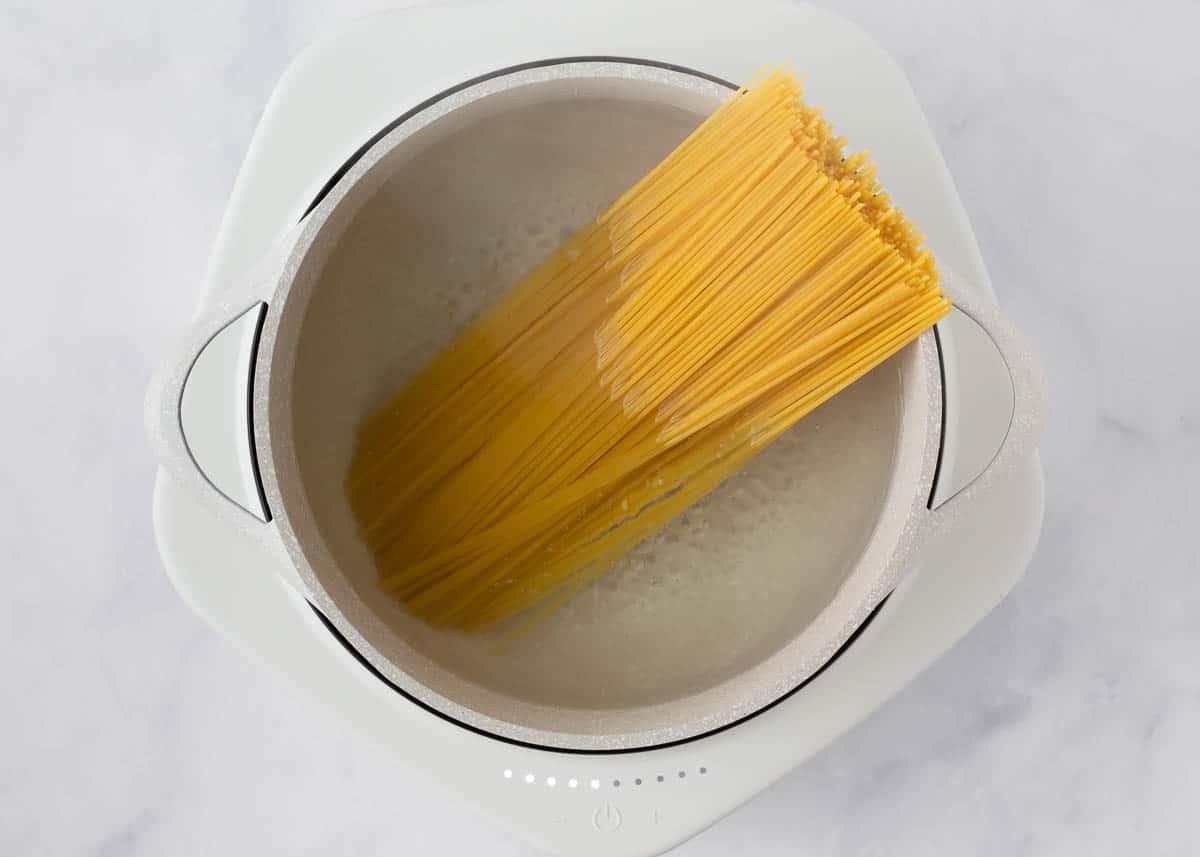 Cooking pasta in a white pot.