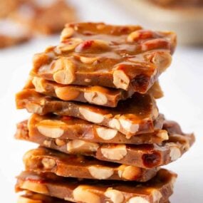 Stack of peanut brittle on a white counter.