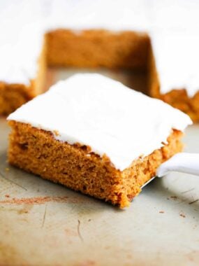 Slice of a pumpkin bar with cream cheese frosting.