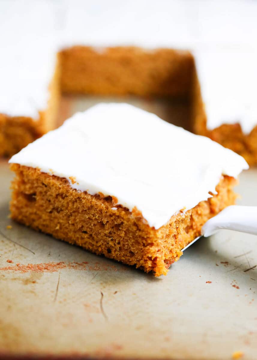 Slice of a pumpkin bar with cream cheese frosting.