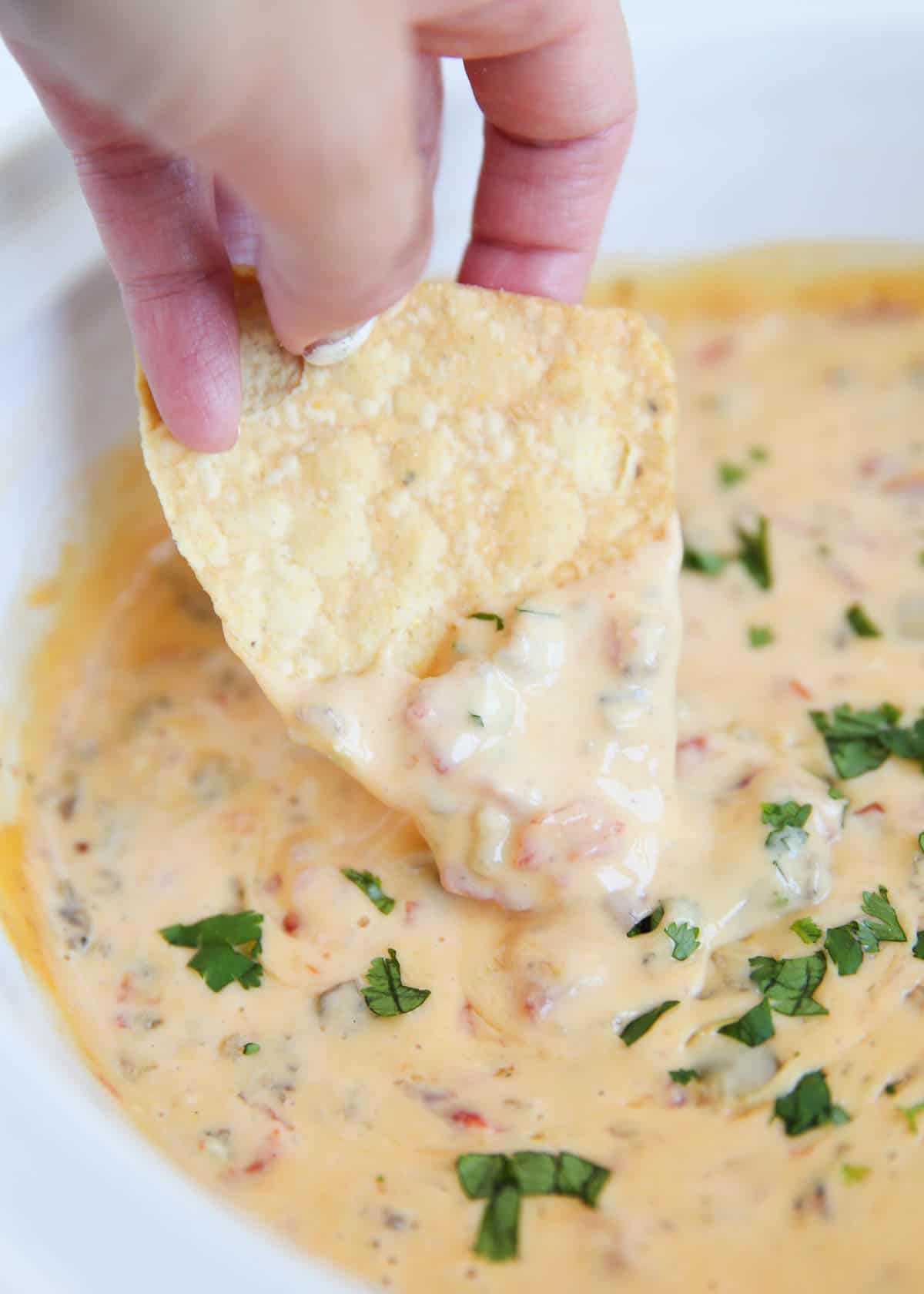 Dipping chip into rotel dip. 