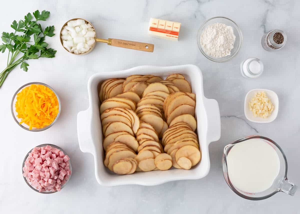 Scalloped potatoes and ham ingredients on counter.