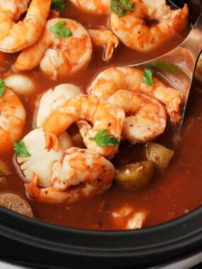 Ladle full of seafood stew.