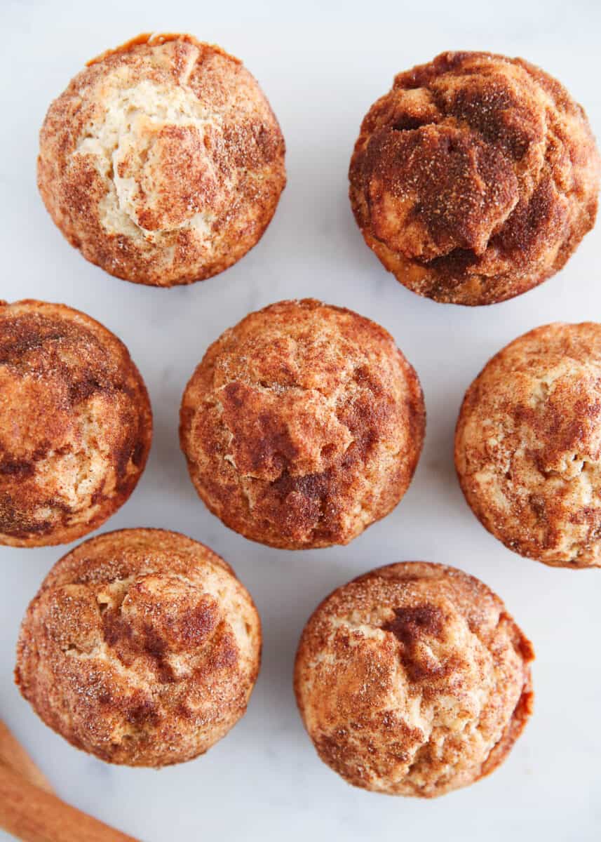Snickerdoodle muffins on marble countertop.