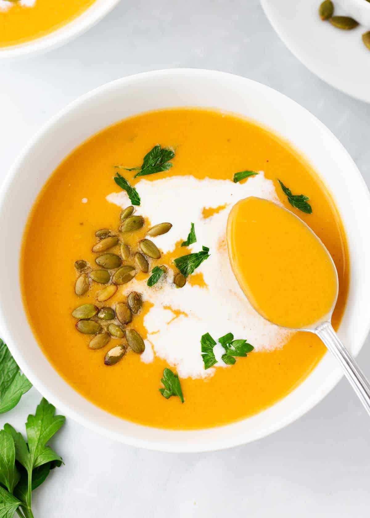 Sweet potato soup in a white bowl.