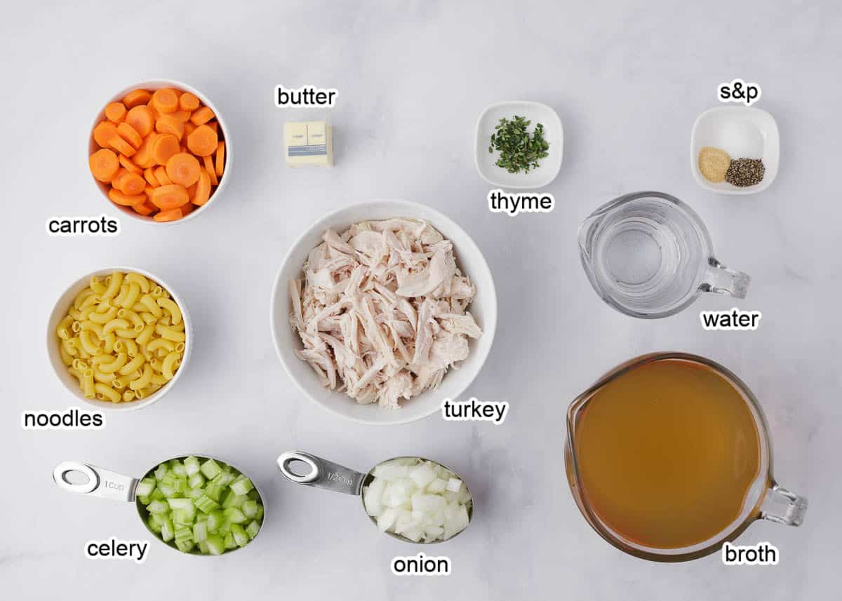 Turkey soup ingredients on a marble counter.