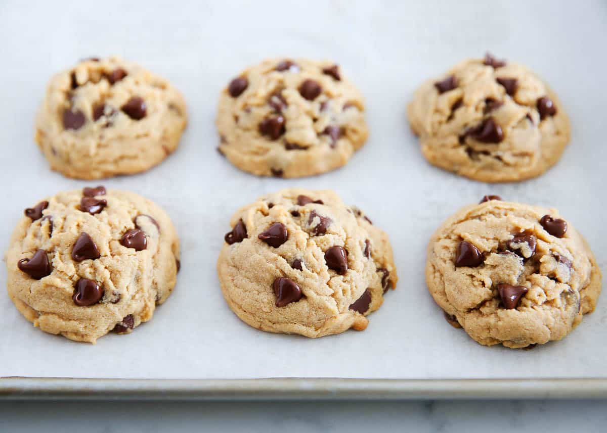 Peanut butter chocolate chip cookies on a baking pan.