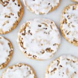 Iced oatmeal cookies on the counter.