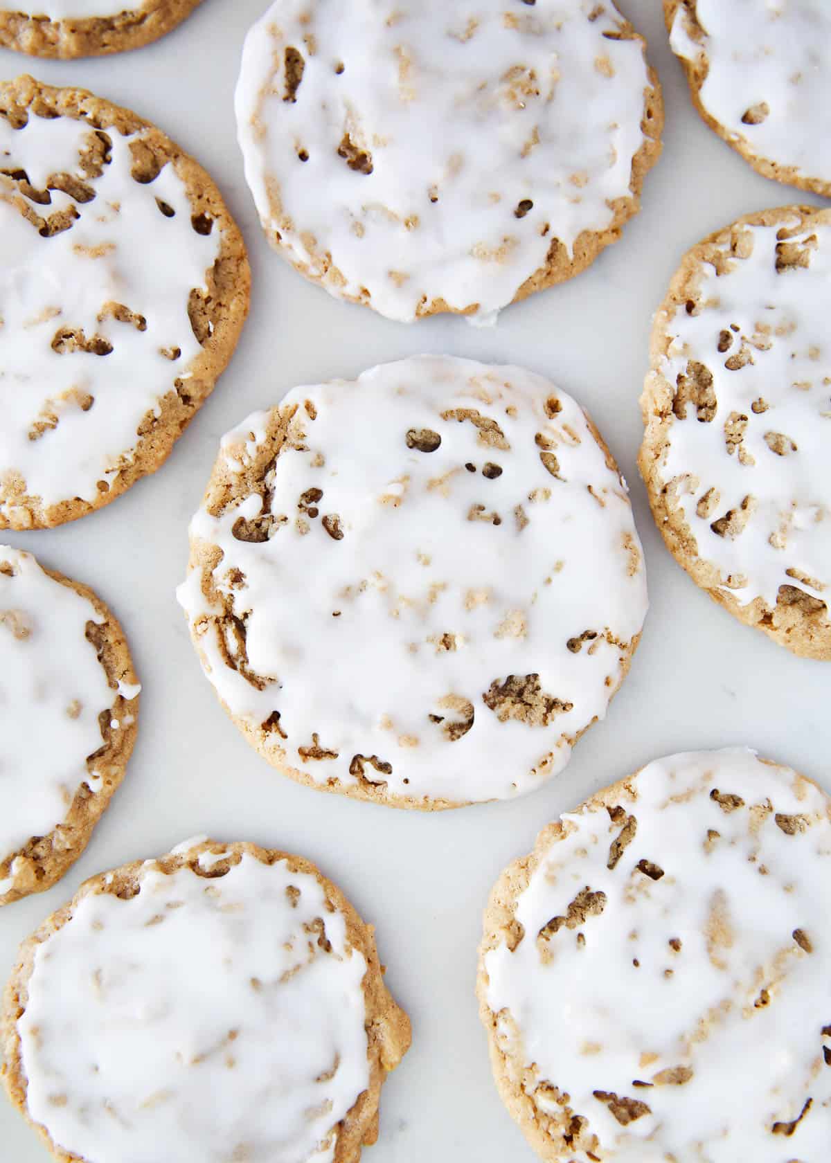 Iced oatmeal cookies on the counter.