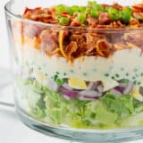 7 layer salad in a glass bowl.