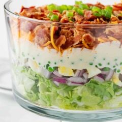 7 layer salad in a glass bowl.